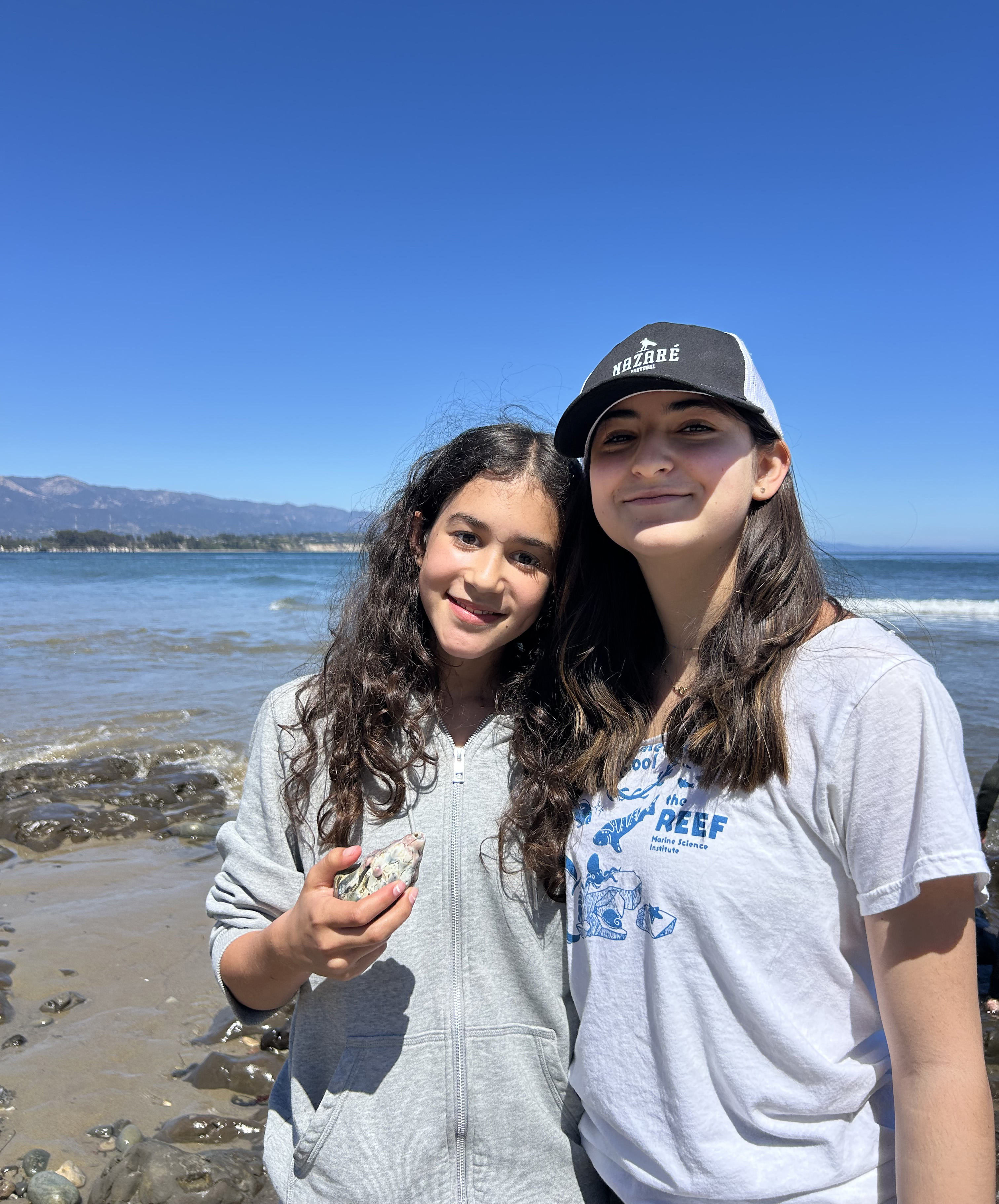 Close up of two REEF girl friends posing on the beach