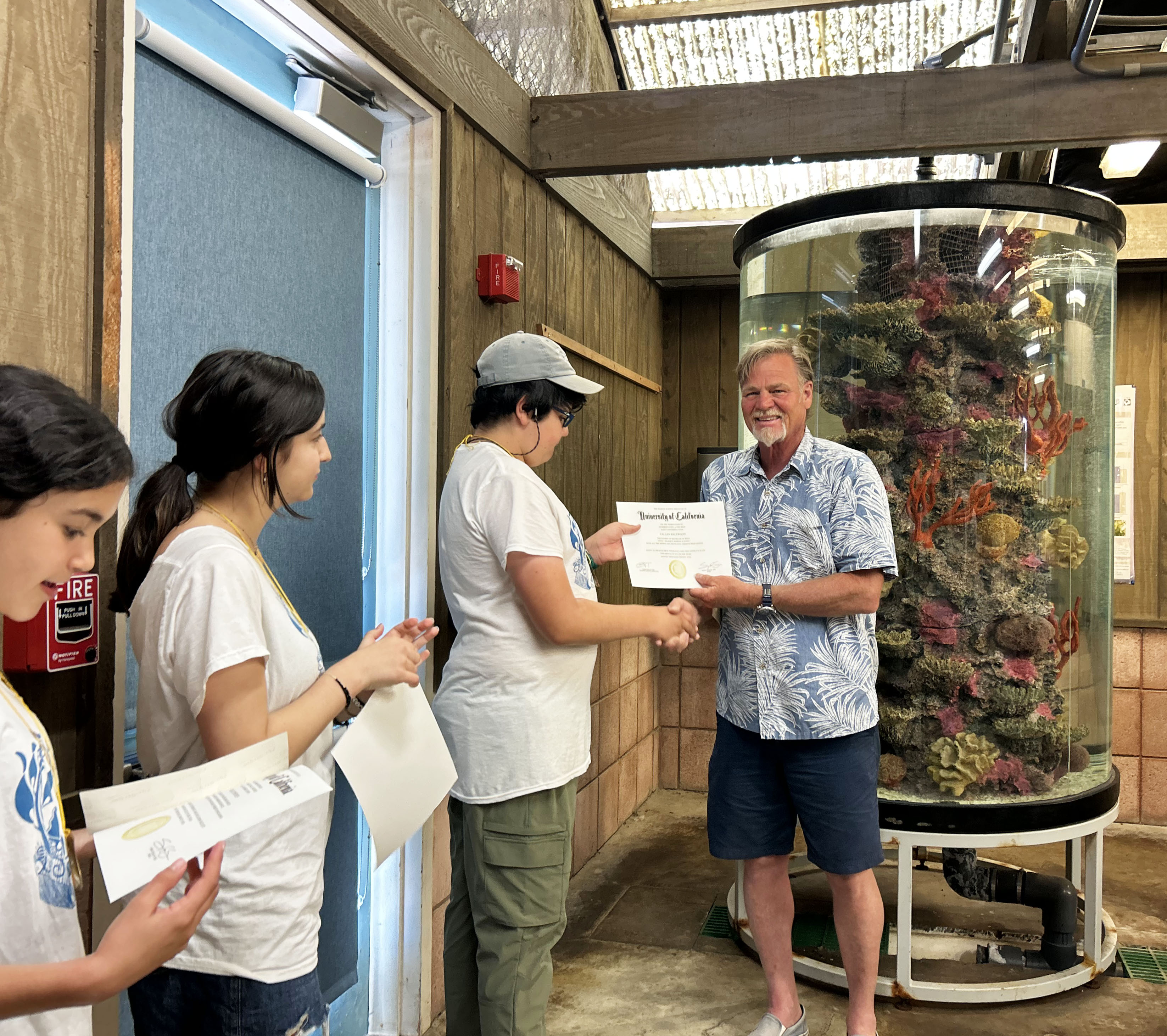 REEF graduation, Scott hands diploma to Callan