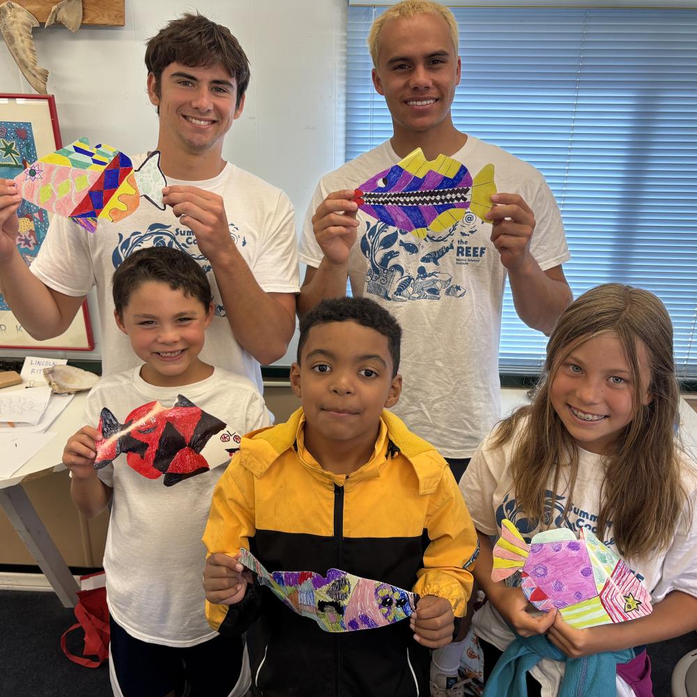Reef campers and docents showing their art projects